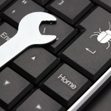 registry reviver registry cleaner software features wrench on black computer keyboard debug key